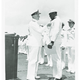 Doris Miller receives the Navy Cross from Adm. Chester W. Nimitz at an awards ceremony held on the flight deck of the USS Enterprise at Pearl Harbor.